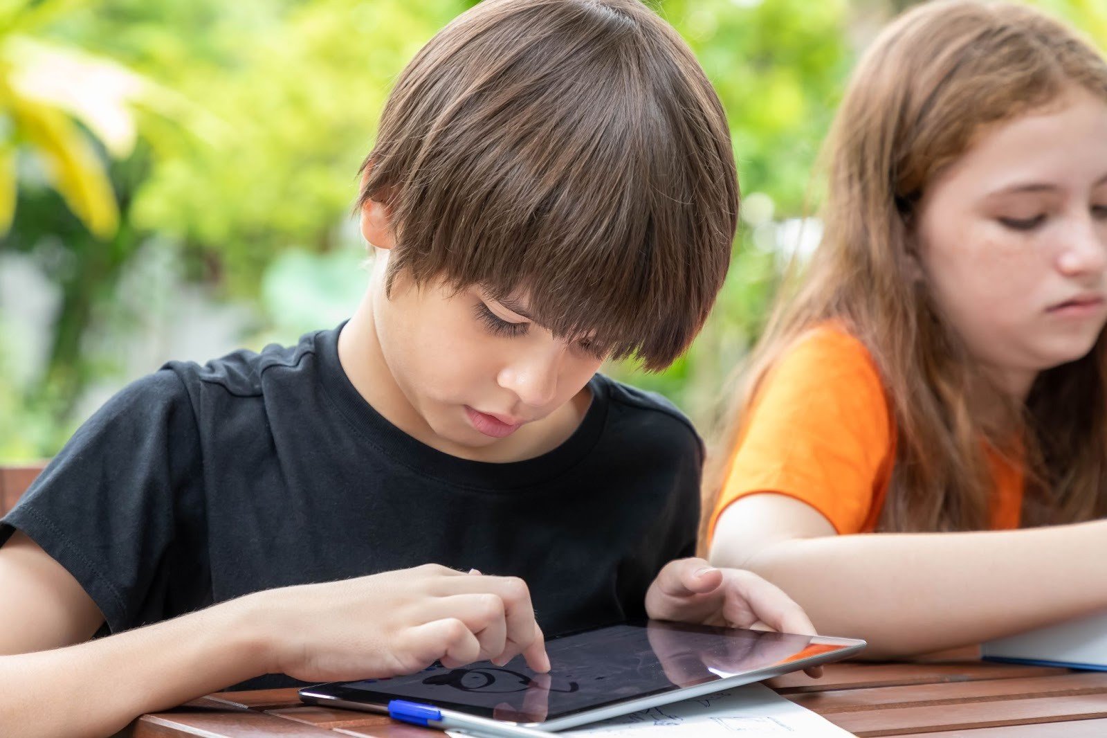 Kids engaged in learning through a digital device
